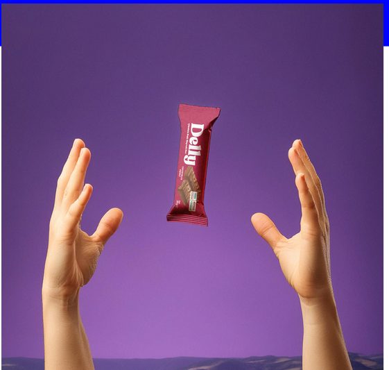 Hands tossing a Delly bar into the air